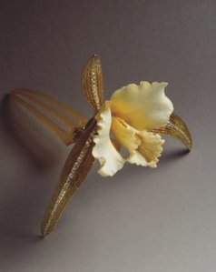René Lalique (French, 1860-1945). Cattleya Orchid Hair Ornament. Carved ivory, horn, gold, enamel on gold, diamonds, 1903-1904. Private collection. Photo: Laurent Sully Jaulmes. © Artists Rights Society (ARS), New York/ADAGP Paris.