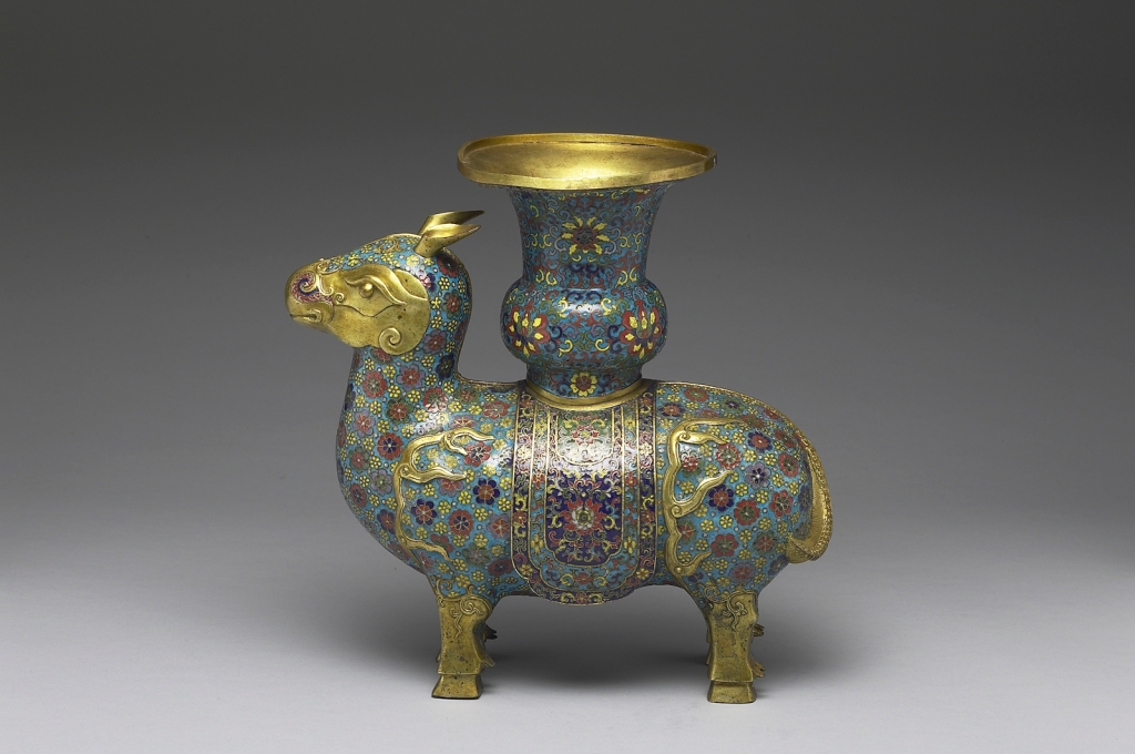 Copper vessel in the shape of a xizun, an ox-like mythical beast, by the Imperial Workshop, Beijing, Qing dynasty, reign of Emperor Qianlong (1736–1795). Based on a classical Bronze Age ritual wine-serving vessel. Qianlong court documents reveal that it was set on an altar in the main hall of the Imperial Ancestral Temple. The stylized floral patterns, filled with multicolored enamel cloisonné, represent the fine level of enamel inlay during the mid and late Qing dynasty. The beast displays design elements commonly found in Persian objects. National Palace Museum, Taipei. Photograph © National Palace Museum